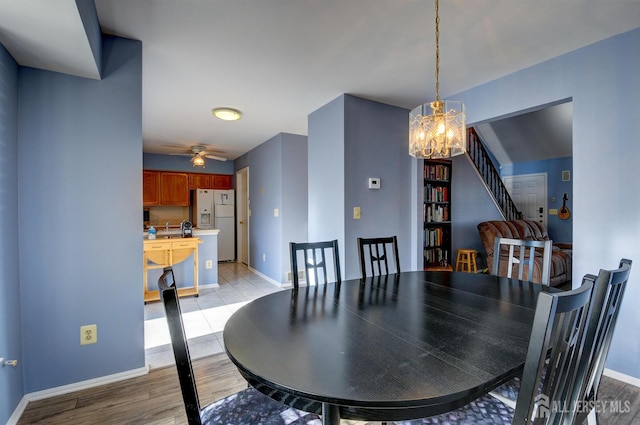 277 Edgeware Ct, Franklin, NJ 08873 - dining space featuring a chandelier, light wood-style flooring, ceiling fan, and stairs