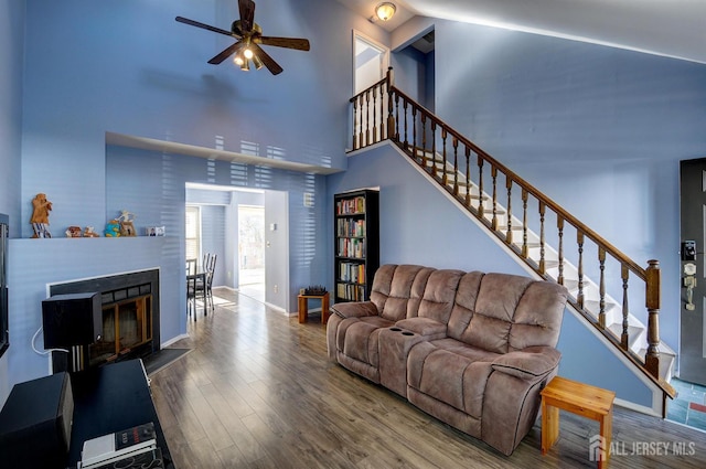 277 Edgeware Ct, Franklin, NJ 08873 - living room featuring high vaulted ceiling, ceiling fan, stairs, wood finished floors, and a glass covered fireplace