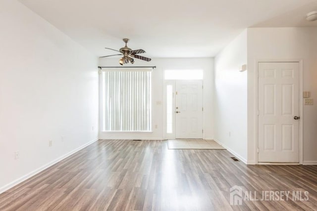 spare room featuring wood-type flooring and ceiling fan