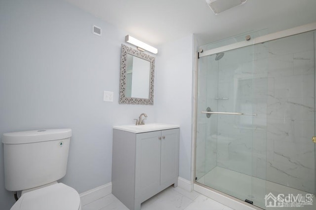 bathroom with vanity, toilet, and an enclosed shower