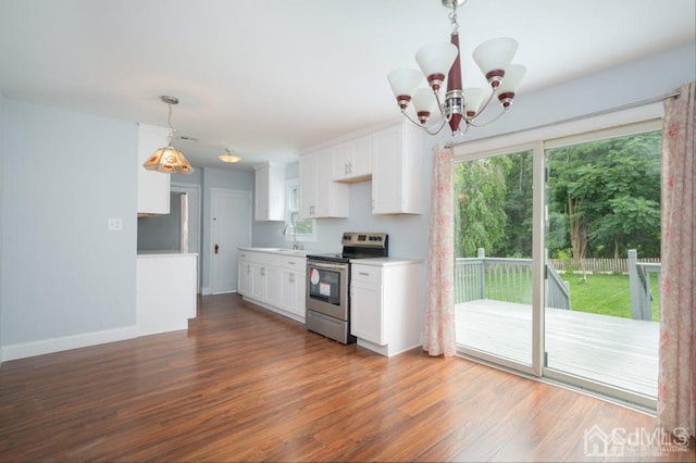 kitchen featuring dark wood-type flooring, white cabinetry, electric stove, and pendant lighting