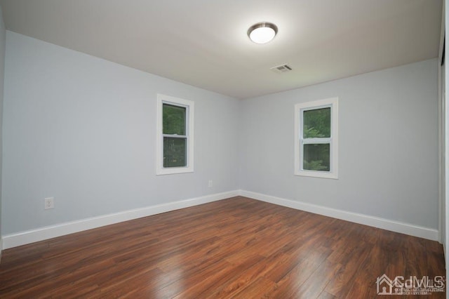 spare room featuring dark hardwood / wood-style floors