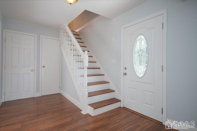 foyer entrance with dark hardwood / wood-style floors