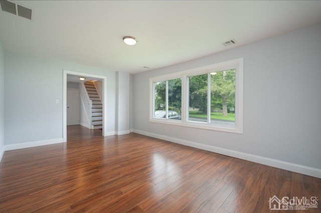 empty room featuring dark wood-type flooring