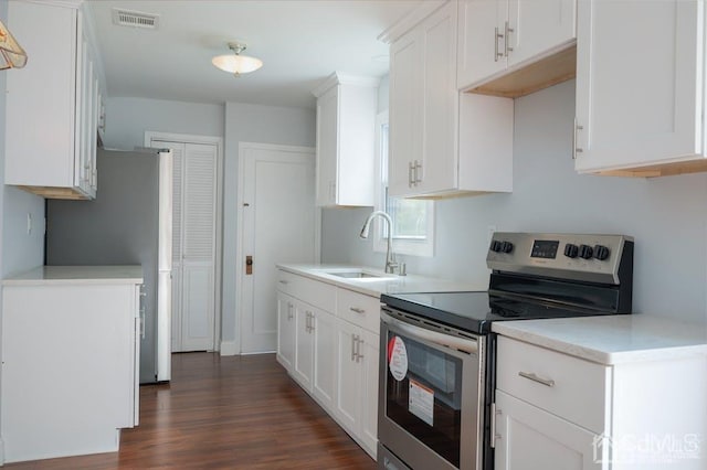 kitchen featuring white cabinetry, dark wood-type flooring, sink, and stainless steel range with electric cooktop