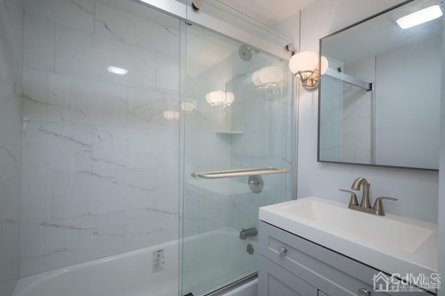 bathroom with vanity and combined bath / shower with glass door