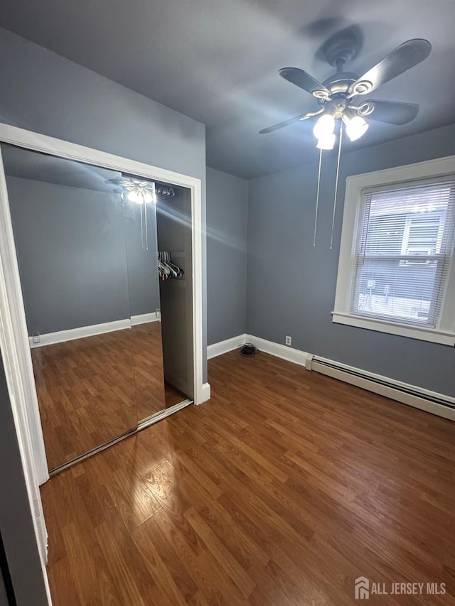 74 Spring St, Woodbridge Proper, NJ 07095 - unfurnished bedroom featuring wood finished floors, a closet, a baseboard radiator, and ceiling fan