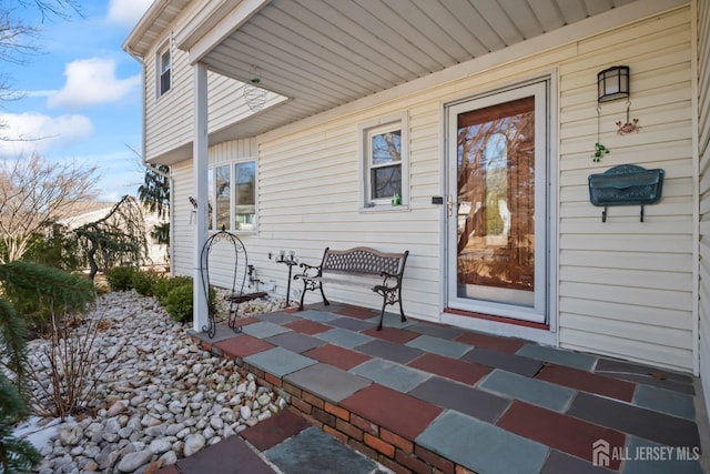 view of exterior entry with covered porch