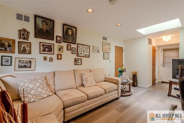 64 Netherwood Cir, Edison, NJ 08820 - living room featuring a skylight, light wood-style floors, and recessed lighting