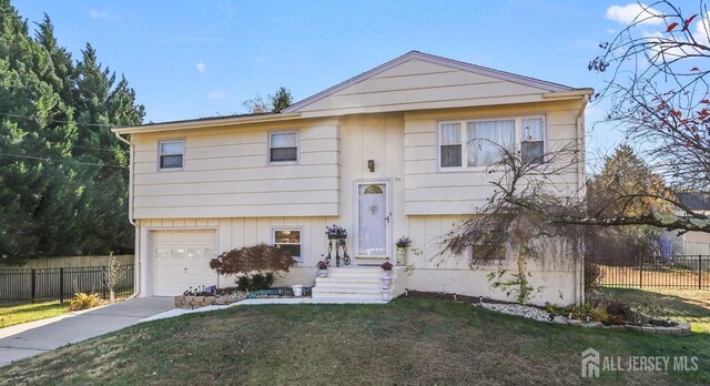 view of front of home with a front lawn and a garage