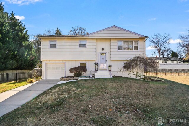 bi-level home featuring a front lawn and a garage