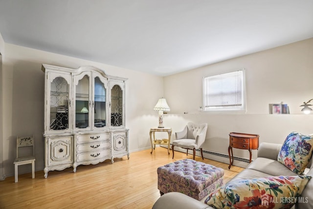 living area featuring baseboard heating and light wood finished floors