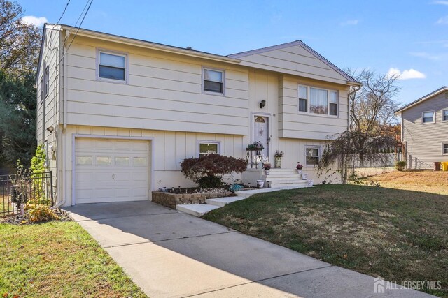 bi-level home featuring a front yard and a garage