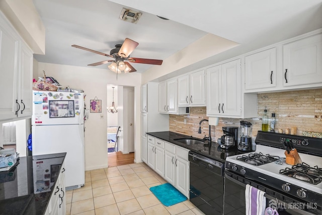 kitchen with white cabinets, dishwasher, range with gas cooktop, freestanding refrigerator, and a sink