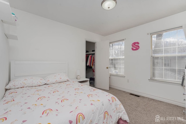 unfurnished bedroom with carpet, a closet, visible vents, and baseboards