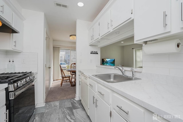 kitchen with visible vents, light countertops, white cabinetry, a sink, and stainless steel gas range oven