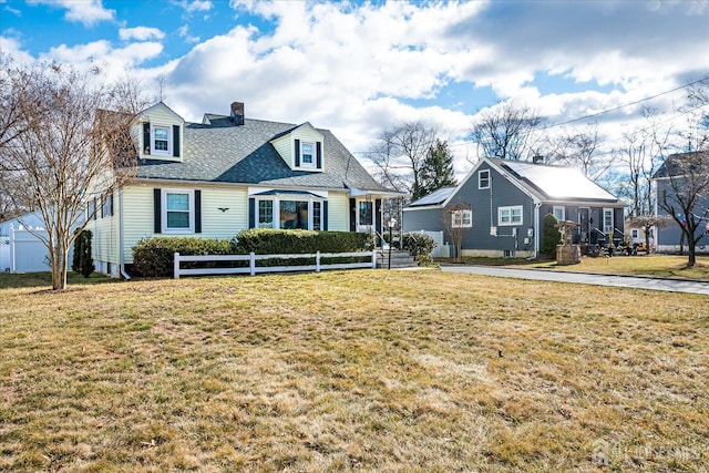 cape cod-style house featuring a front yard