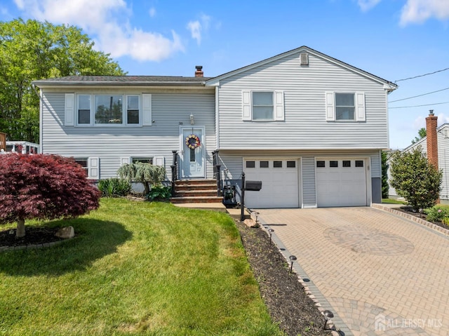 35 Amherst St, South River, NJ 08882 - bi-level home featuring a garage, decorative driveway, a front yard, and a chimney