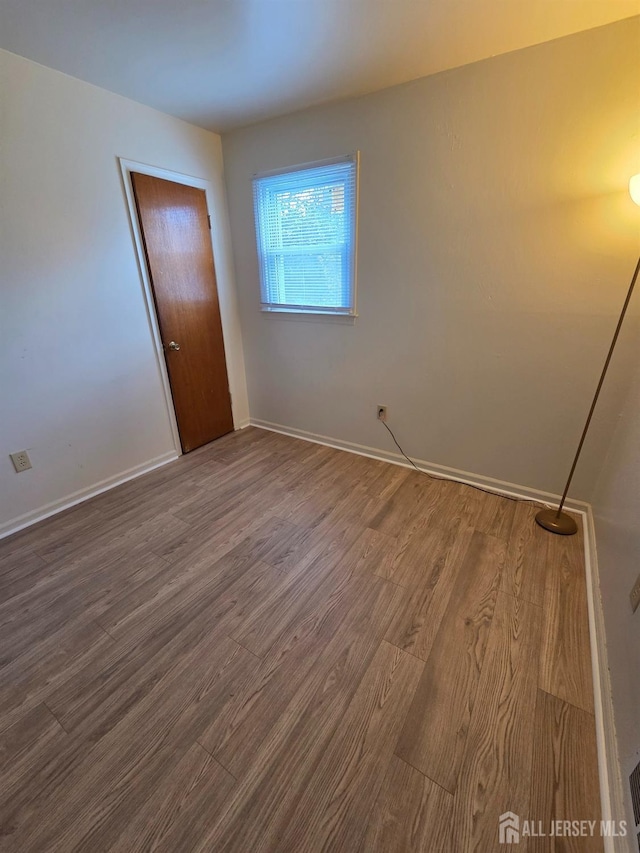 410 Harvard St, Piscataway, NJ 08854 - spare room with dark wood-style flooring and baseboards