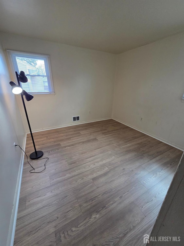 410 Harvard St, Piscataway, NJ 08854 - empty room with wood finished floors and baseboards