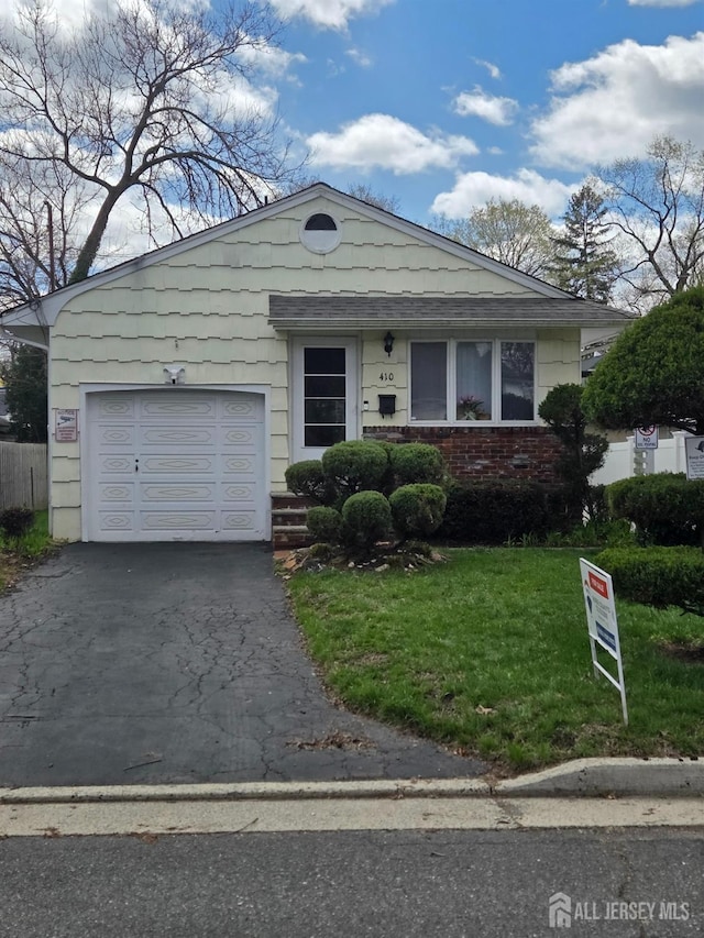 410 Harvard St, Piscataway, NJ 08854 - view of front of property with asphalt driveway, a front lawn, a garage, and brick siding