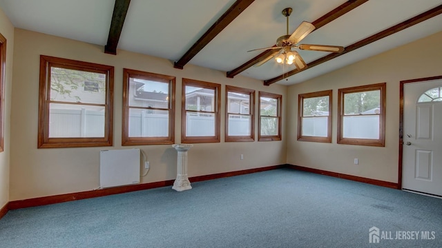 carpeted spare room with a ceiling fan, baseboards, and heating unit