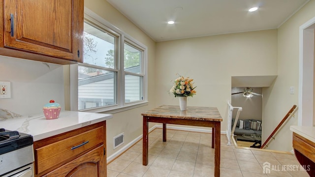 interior space with light tile patterned floors, a ceiling fan, visible vents, baseboards, and recessed lighting