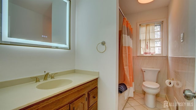 full bathroom featuring a shower with curtain, tile walls, toilet, tile patterned flooring, and vanity