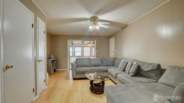 living room with ceiling fan, light wood-type flooring, and baseboards