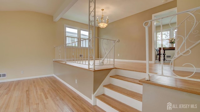 1487 Columbia Dr, North Brunswick, NJ 08902 - stairway featuring wood finished floors, baseboards, and a chandelier