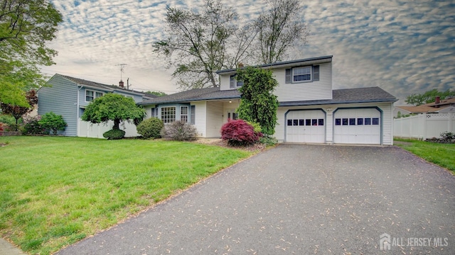 view of front of house with asphalt driveway