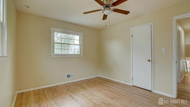 unfurnished bedroom featuring light wood finished floors, baseboards, and visible vents
