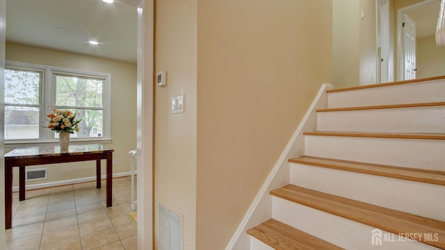 stairway with recessed lighting, baseboards, visible vents, and tile patterned floors