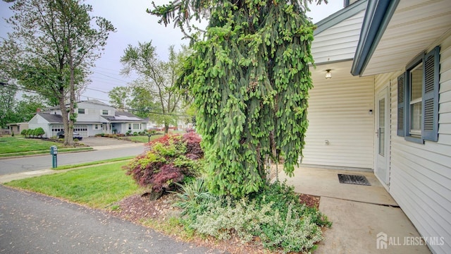 view of side of property with a yard