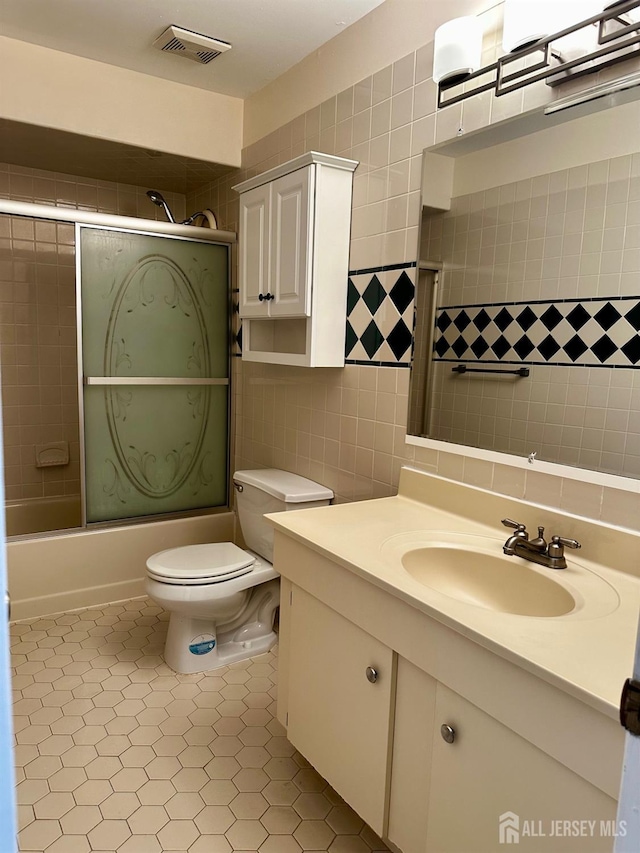 16 Sassafras Ct, North Brunswick, NJ 08902 - full bath with vanity, tile walls, combined bath / shower with glass door, and tile patterned floors