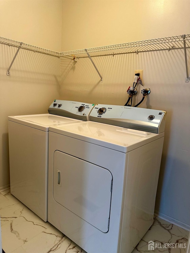 16 Sassafras Ct, North Brunswick, NJ 08902 - laundry room featuring washing machine and clothes dryer and light marble finish flooring