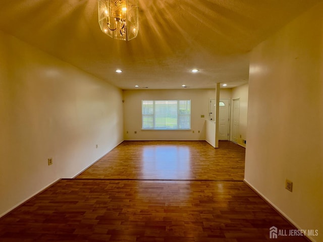 16 Sassafras Ct, North Brunswick, NJ 08902 - unfurnished living room featuring wood finished floors, a chandelier, and recessed lighting