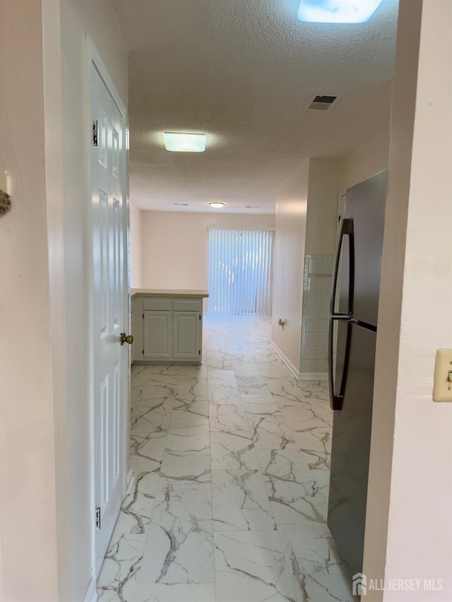 16 Sassafras Ct, North Brunswick, NJ 08902 - corridor with a textured ceiling and light marble finish floors