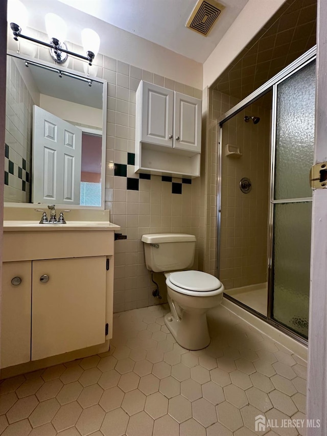 16 Sassafras Ct, North Brunswick, NJ 08902 - full bath with vanity, a shower stall, tile walls, and tile patterned floors