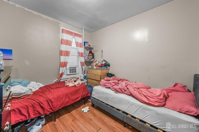 bedroom with hardwood / wood-style floors