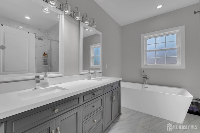 bathroom with a marble finish shower, a soaking tub, marble finish floor, and a sink