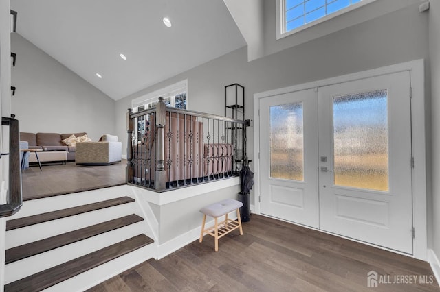 foyer entrance with high vaulted ceiling, wood finished floors, recessed lighting, french doors, and baseboards