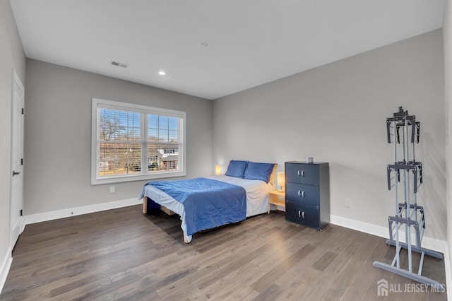 bedroom with recessed lighting, visible vents, baseboards, and wood finished floors