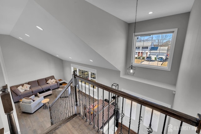 hall with recessed lighting, an upstairs landing, wood finished floors, and vaulted ceiling