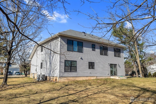 rear view of house with a yard