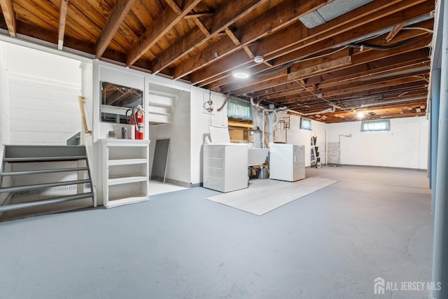 below grade area featuring washer and clothes dryer, stairs, and a sink