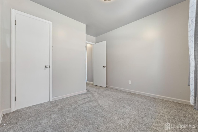 unfurnished bedroom featuring baseboards and carpet floors