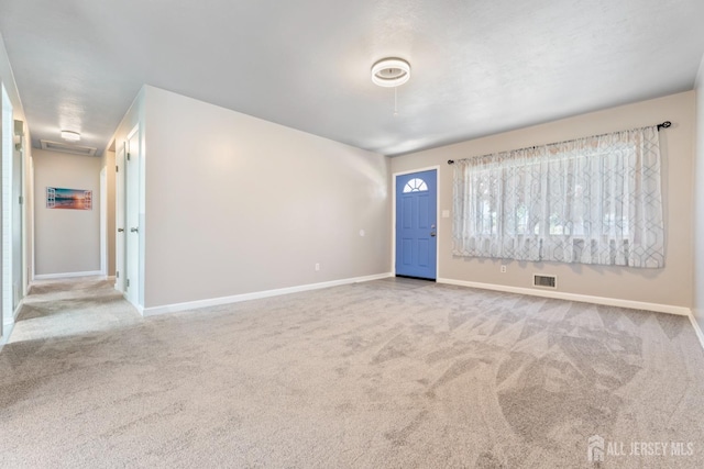 interior space with carpet, visible vents, and baseboards