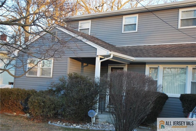 view of front of house featuring roof with shingles