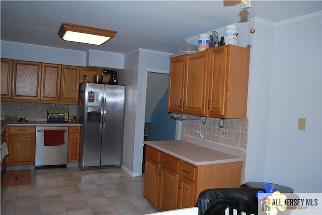 kitchen with brown cabinets, stainless steel appliances, tasteful backsplash, light countertops, and ornamental molding